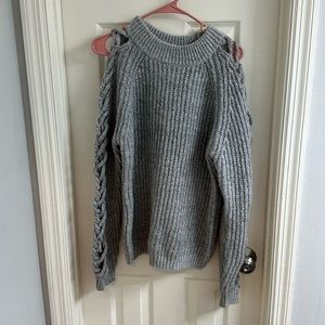 Grey sweater with braided knitting up both arms